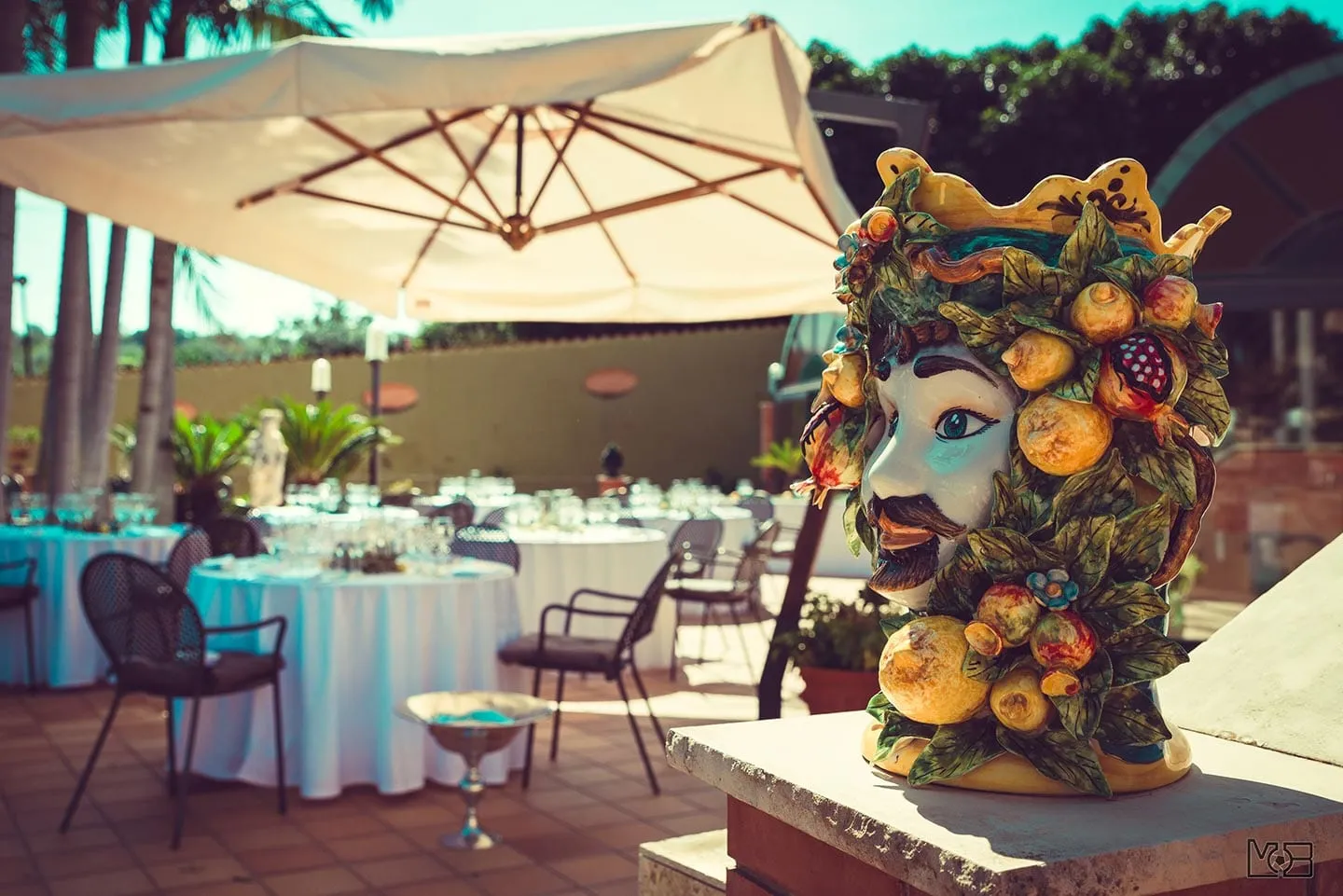 Table set by the pool with sea view