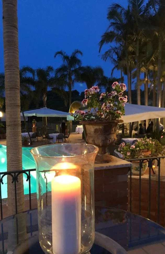 Tables with white tablecloths by the pool