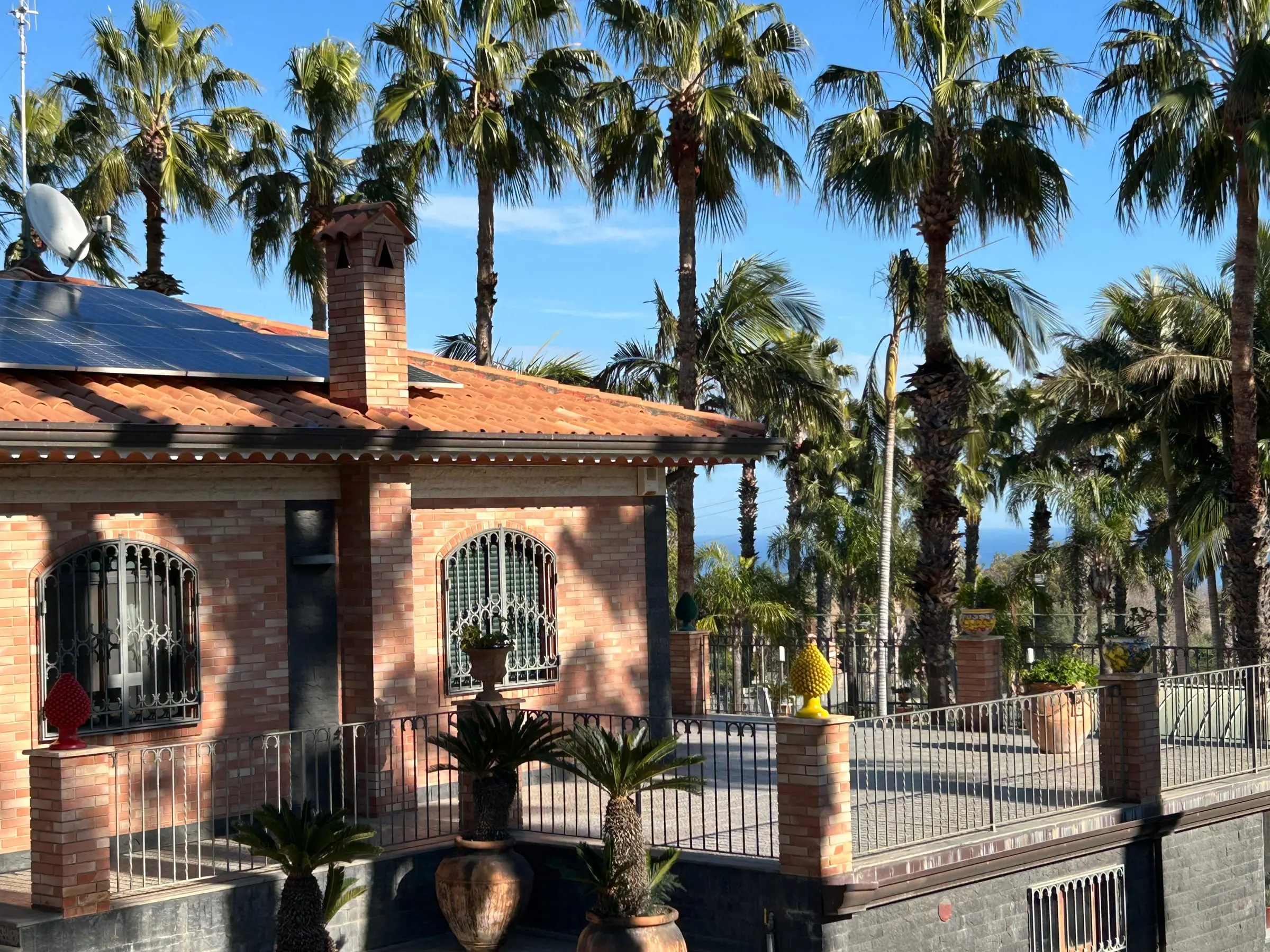 The brick guest house among the palm trees